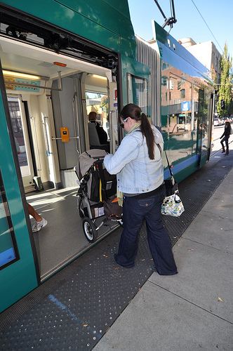 Wife loading stroller onto Streetcar