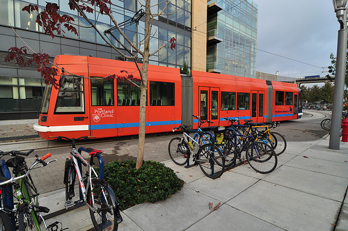 Streetcar in the South Waterfront District flanked by many parked bikes